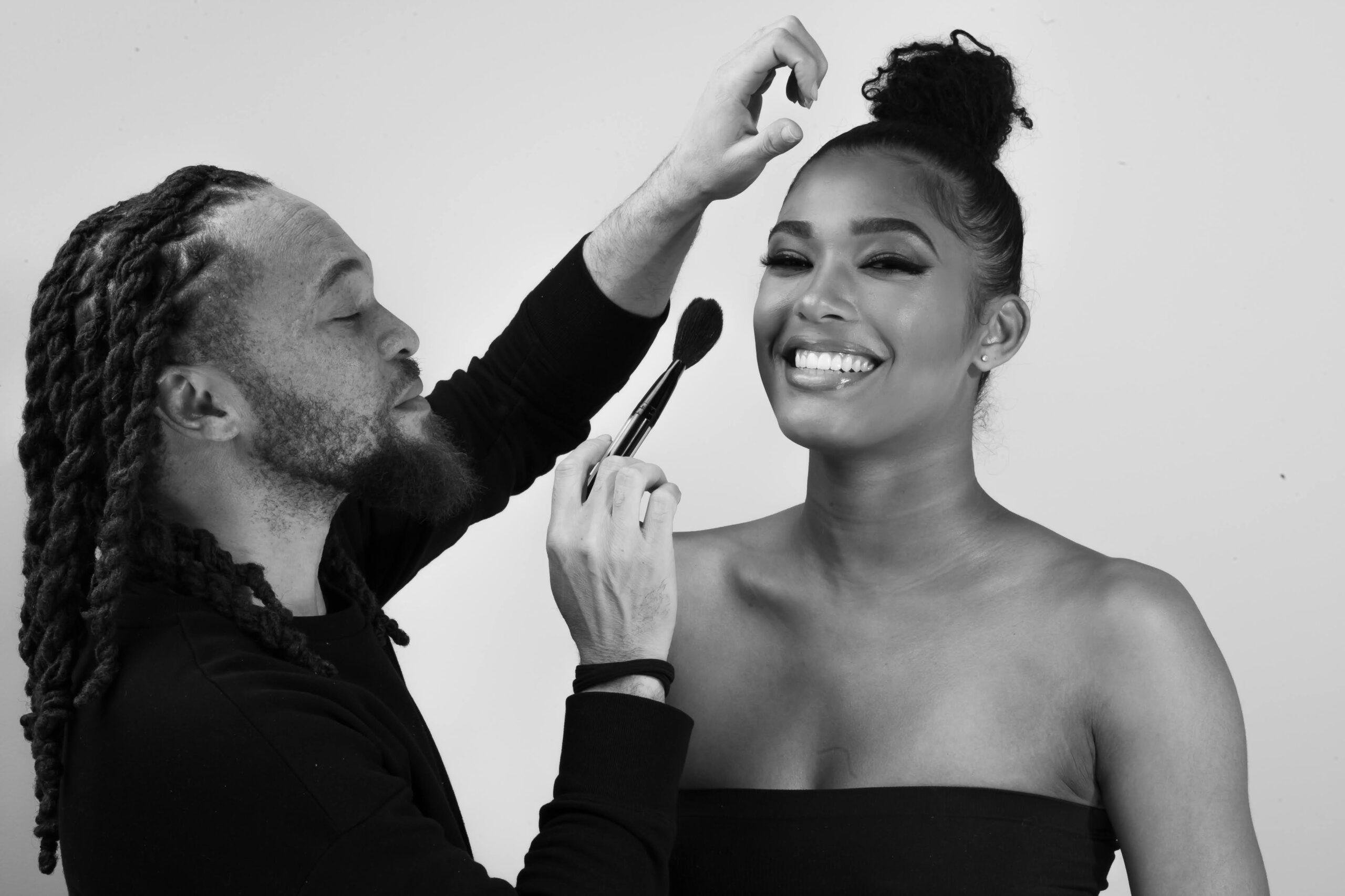 Pro makeup artist applying finishing touches — She’s The B.O.S.S.